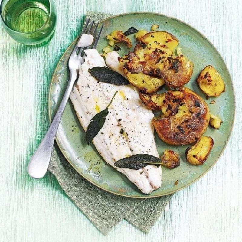 Garlic and sage smashed jersey royals with pan-friend sea bass